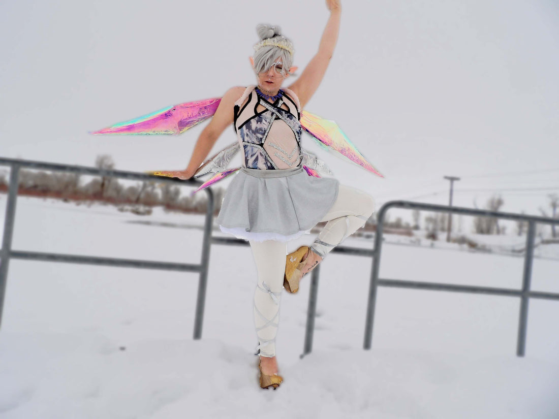 Ice Fairy dancing in the snow with iridescent prism shaped wings and a tutu