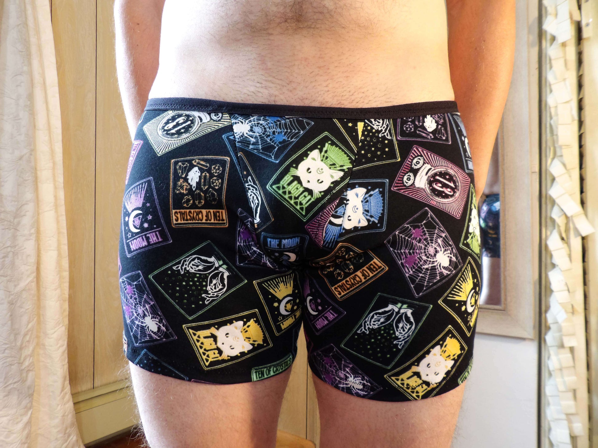 model wearing unique neon tarot boxer briefs
