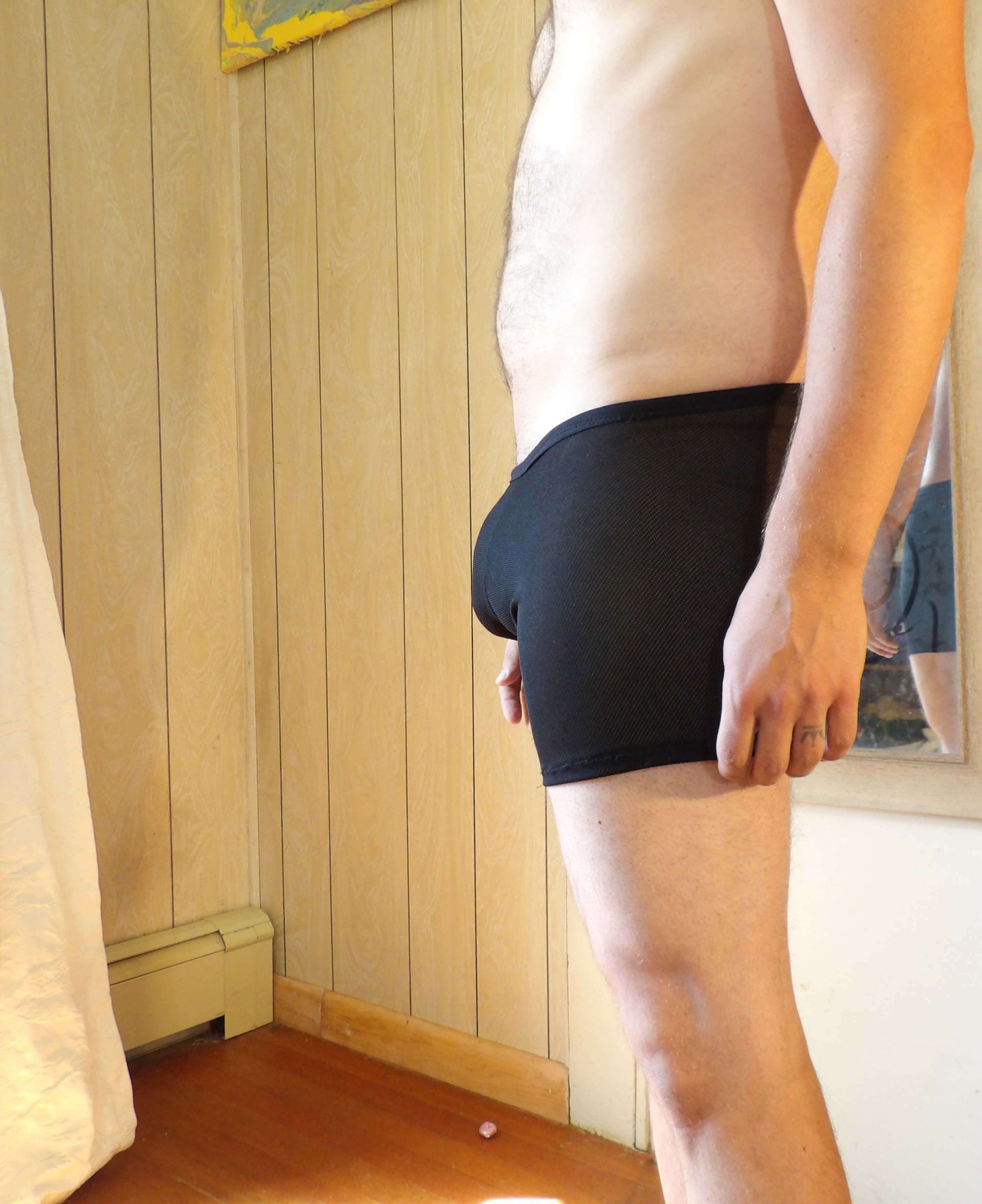man in black mesh boxer briefs