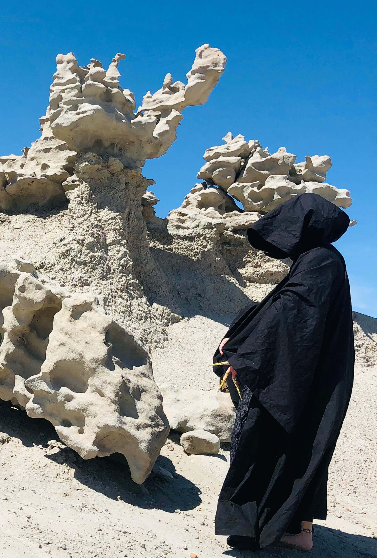side profile mysterious black cloaked figure