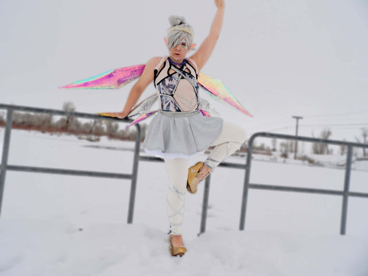 Ice Fairy dancing in the snow with iridescent prism shaped wings and a tutu