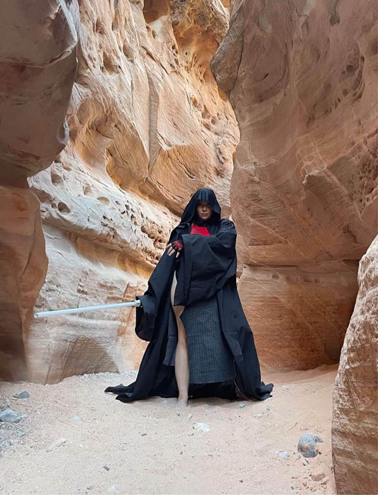sith cosplay with saber in desert