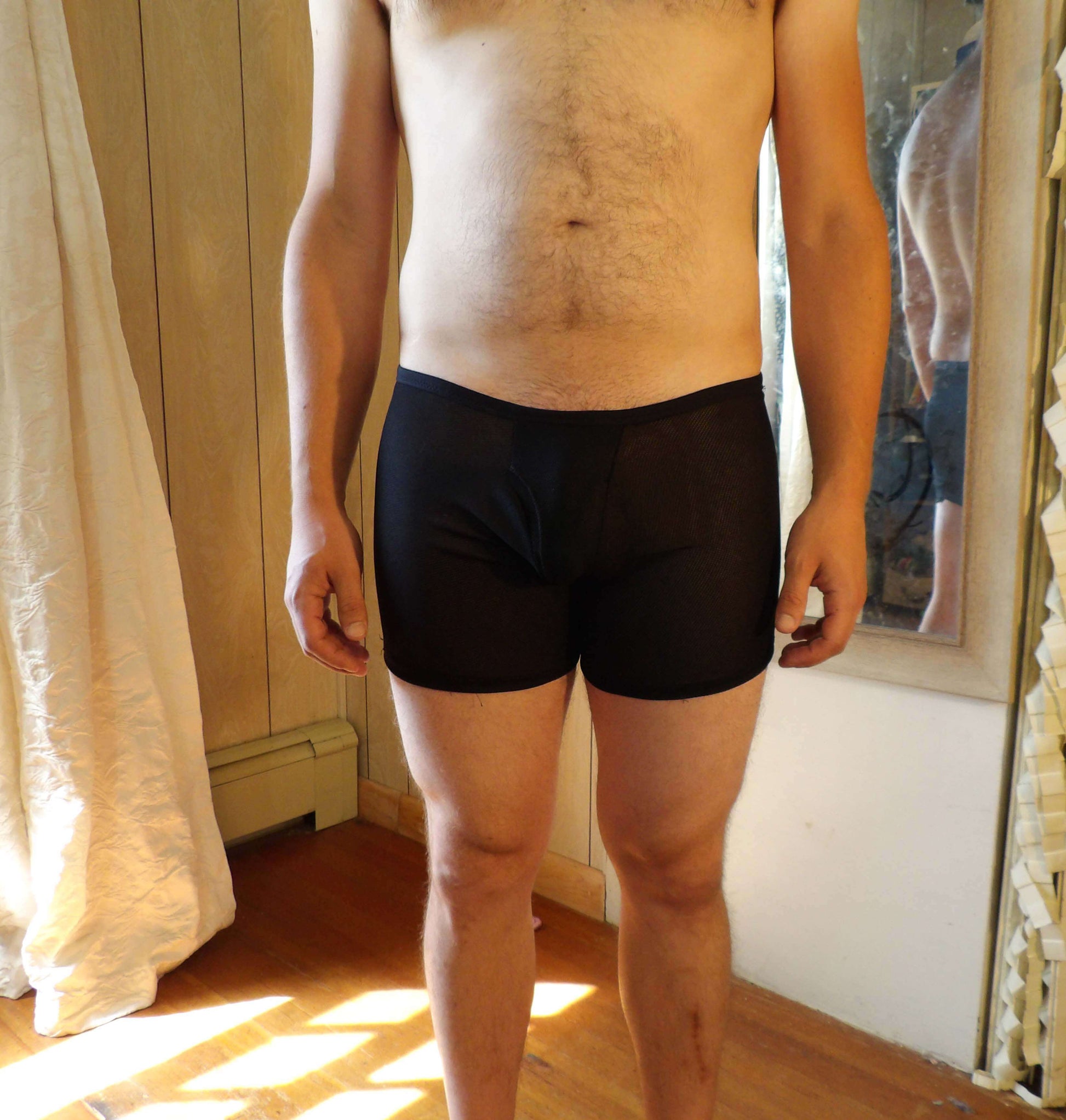 shirtless man in black mesh boxer briefs