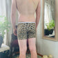 back of model in cheetah print boxer briefs
