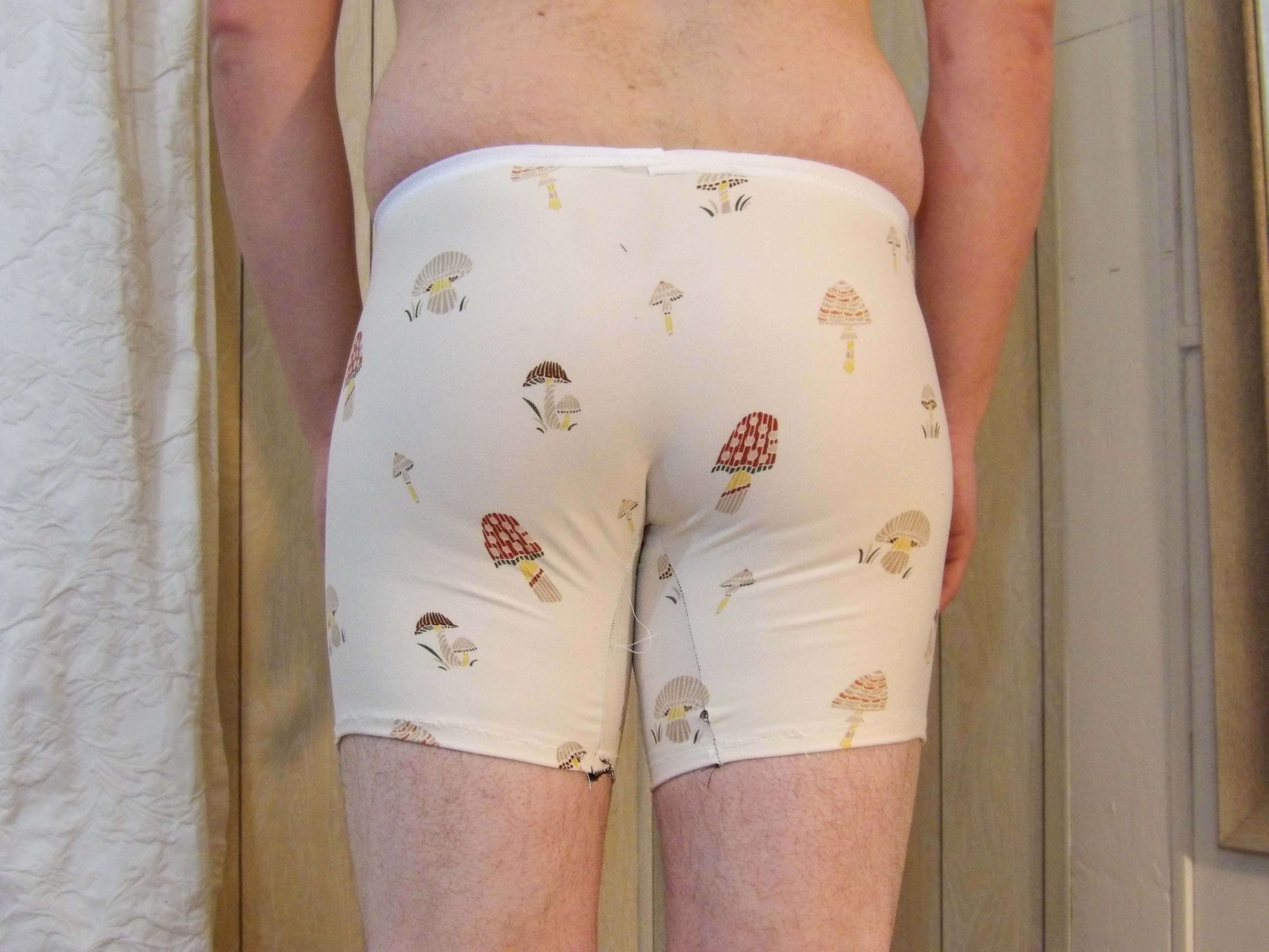 back of male model in unique mushroom pattern boxer briefs