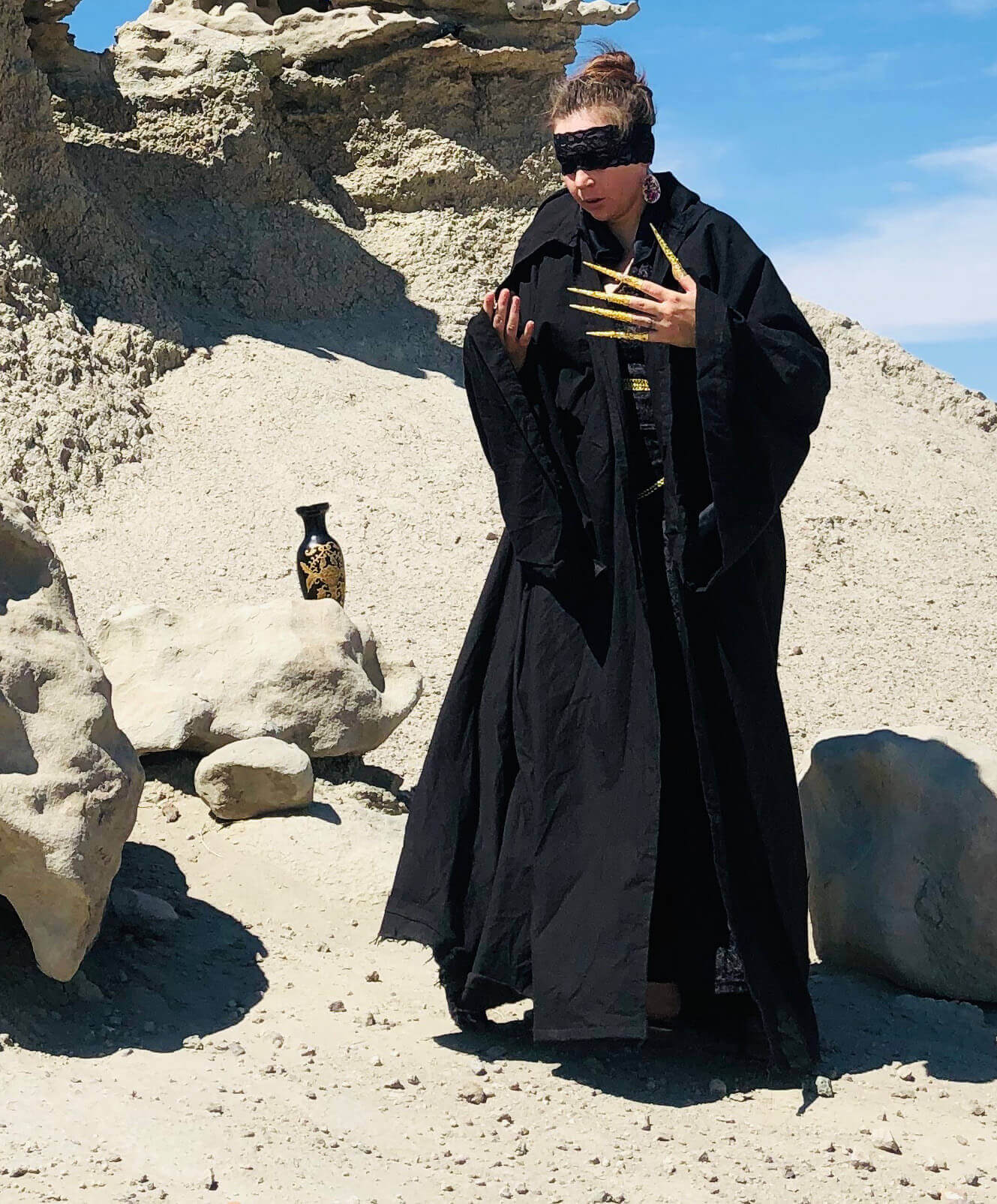 model cloaked in black full robe